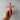 Hand holding a wooden cross against a plain background