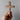 Wooden cross held in a hand against a gray background