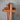 Wooden cross with layered wood design on a gray background
