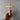Hand holding a wooden cross against a gray background