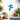 Decorative blue frog wall art in an outdoor setting with plants and a pool.