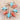 Pair of earrings with turquoise and red stones on a stone surface