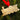 Gold train ornament on a green pine branch with a red ribbon