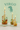 Three lit candles in glass bottles with floral elements on a light green background with 'Virgo' text.