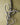 Metal heart-shaped cross close-up on a wooden wall