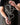 Person holding a metal cross with interlocking hearts