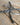 Metal cross close-up on a wooden surface