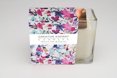 Soy Lotion Candle with a colorful floral packaging label on a white background