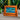 Cheery Wood Framed Moving sand picture on table with plants in the background