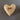 Wooden heart-shaped object with 'faith' engraved on a gray background