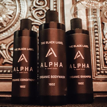Three Alpha Alpha  100%  Organic Men's Shampoo by Johnny Cliche bottles on a decorative background