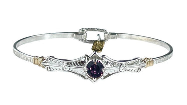Silver bracelet with a purple gemstone on a white background