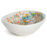 White ceramic bowl with colorful speckled interior on a white background