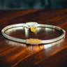Gold and silver bracelet on a wooden surface