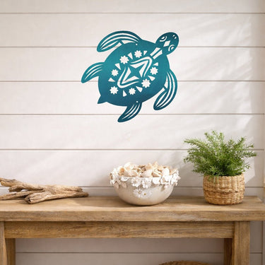 Teal turtle wall decal on a wooden shelf with decorative items