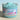 Jar of 'Beach Babe' whipped body scrub with a label on a light background