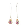 Pair of earrings with pink gemstones and gold wire wrapping on a white background