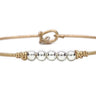 Bracelet with gold and silver beads on a white background