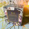 Boxed Blooms and Berries Soy Lotion Candle with a decorative background