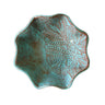 Turquoise ceramic bowl with textured design on a white background