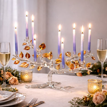 Tree of Life Menorah, Fall Color Leaves with lit candles on a table setting with wine glasses and flowers.