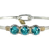 Silver bracelet with three turquoise stones on a white background