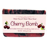 Bar of soap labeled 'Cherry Bomb Natural Goat Milk Soap Charcoal and Cranberry Seed Scrub' with a visible brand name on a white background