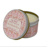 Candle in a decorative tin with a pink and white design on a white background