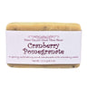 Bar of Cranberry Pomegranate Goat Milk Soap Exfoliating Bar with a white label on a white background