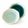 Two ceramic bowls with green and blue glaze on a white background