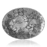 Decorative metal plate with floral design on a white background