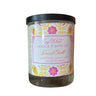 Candle with a decorative label on a white background