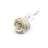 White ceramic rose with gold accents on a white background