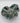 Emerald City Blossom Bowl  leaf-shaped dish with green and brown glaze on a white background