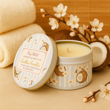 Candle tin with floral design and visible brand name on a with to and flowers in backgroundl