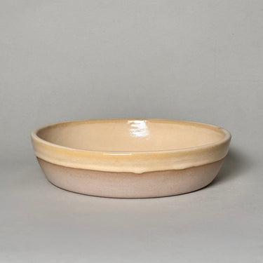 Beige ceramic bowl on a gray background