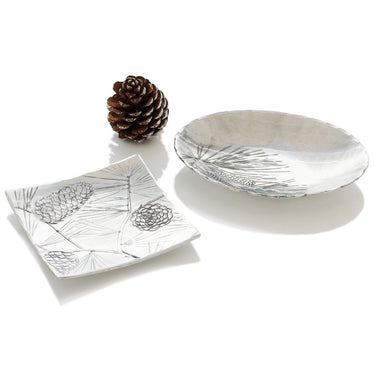 Decorative glass plates with floral patterns on a white surface.