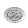 Round metallic object with engraved text on a white background