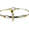 Silver and gold bracelet with a cross charm on a white background
