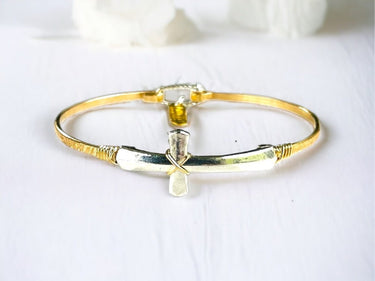 Gold and silver bracelet on a white background