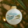 Decorative Christmas ornament with a painted boat on a white background, hanging on a tree.