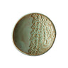 Ceramic ring dish with textured design on a white background