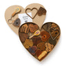 Heart-shaped box filled with wooden heart-shaped items and a keychain, on a white background.