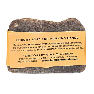 Bar of Natural goat milk hand soap for hardworking hands with a label on a white background