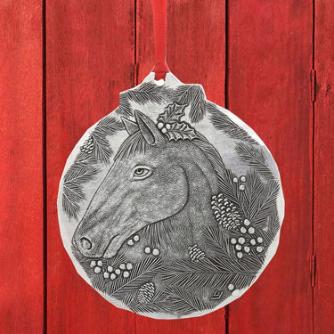 Decorative ornament with a horse design on a red wooden background