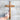 Wooden cross held against a concrete wall