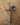 Decorative cross with a hummingbird on a wooden surface