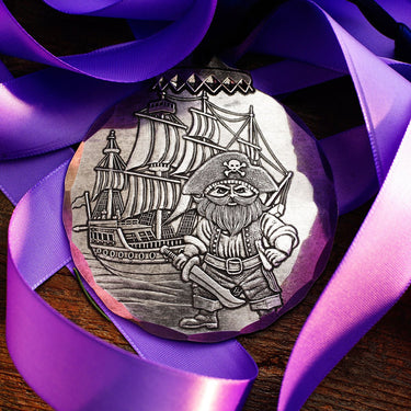 Pirate-themed coin with ship and character on purple ribbons