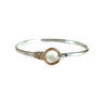 Silver bracelet with a circular design on a white background