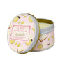 Candle in a decorative tin with lemon design on a white background